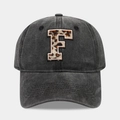 Detailed close-up of leopard print letter F embroidery on vintage washed cotton baseball cap - Letter F