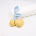 Detail of yellow leather cherry keychain with blue leaf and golden metal clip - Yellow