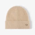 Light camel knit beanie with plush fuzzy texture and circular metal M logo detail - Camel