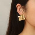 Close-up of model wearing irregular gold-plated stainless steel earrings in French style - Wrinkled Earrings / Gold