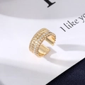 Macro view of gold evil eye ring featuring wavy edges and rows of white zircons - Multi-row Rhinestone Wave