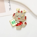 Detailed close-up of a festive dragon charm with white crystals and red enamel accents - Dragon Prosperity - Matte Gold