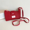 Detail of red knit shoulder bag featuring diamond texture and silver magnetic button - Red
