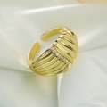 Macro view of 18K gold plated open ring featuring inlaid zircons on a striped band - Wave Texture