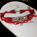 Macro detail of wine red velvet choker with crystal inlay and teardrop pearl pendant - Wine Red Bow Drop Pearl Style
