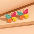 Colorful woven raffia butterfly earrings in vibrant summer shades on a stylish platform - Colorful