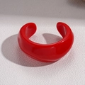 Detail of red irregular resin bangle with high glossy finish on a textured surface - High Gloss Red Chunky Open C-Shape (6#)