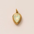 Macro shot of 18k gold plated pear-shaped pendant with faceted iridescent gemstone inlay - October Birthstone Pendant (Opal)