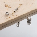Macro shot of silver stainless steel beads with spiral texture on a gold needle - Spiral Pattern (1#) / 2mm