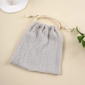Close-up of grey muslin cotton drawstring bag with rope knot and natural texture - Light Gray