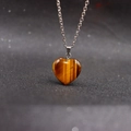 Natural tiger eye stone heart pendant necklace with silver chain on black background - Tiger Eye with Chain