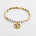 Golden bead stretch bracelet with white pearls and a celestial star charm for women - Star Pearl Gold Bracelet