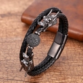 Detail of dragon head charms on black braided leather bracelet with lava stone bead - Dragon Head Lava Stone