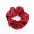 Elegant red satin scrunchie with silk-like texture and glossy folds for women - Red