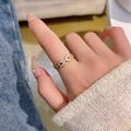 Elegant gold-plated chain link ring with micro-paved white zircons on a denim background - Gold - Interlocking Chain Rings