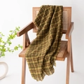 Green and brown plaid scarf with fringe tassels draped on a wooden chair - Curry Yellow