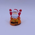 Miniature resin Santa Claus figurine sitting in a bag with Merry Christmas text - Santa Claus