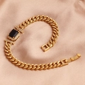 Macro view of gold-plated Cuban chain bracelet with rectangular black gemstone and zircon pavé - Black Zirconia