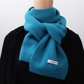 Blue knitted warm winter scarf on a black mannequin, soft textured solid color wrap - Lake Blue