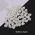 Close-up of heart-shaped 8x9mm cream white imitation pearl beads for DIY jewelry making - 8*9mm Heart
