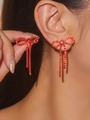 Elegant red rhinestone bowknot long tassel earrings worn by a model for a luxury look - Red Bowknot Full Rhinestone Tassel