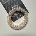 Pastel pink polka dot spiral hair tie on black card holder for daily hairstyles - Polka Dot Fleshy Pink