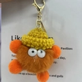 Cute orange mink fur monster keychain with a yellow knit hat and golden clasp charm - Orange