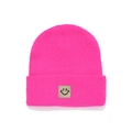 Detail of fuchsia knit beanie featuring a square black smiley face patch and ribbed texture - Rose Red