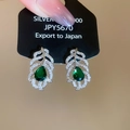 Detail view of silver leaf earrings with emerald water-drop gems and zircon inlay - Green Waterdrop Feather Leaf