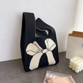 Chic black knitted tote bag featuring a prominent white bow pattern for daily wear - Black And Beige Bow