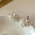 Detailed macro of flower cluster earrings with white pearls on a ceramic dish - Silver Color (18K Gold Plated / 925 Silver Pin)