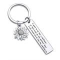 Close-up of engraved stainless steel bar and sunflower charm on a silver keychain - Grow like a sunflower