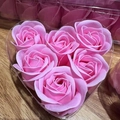 Detail of 6 pink scented soap roses arranged in a heart-shaped gift box on wood - Pink