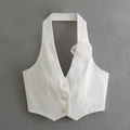 Detail of white halter vest featuring 3-button closure and delicate 3D floral mesh applique - S / White