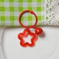Red acrylic star keychain with flower pendant and matching metal bell on plaid background - Transparent Red