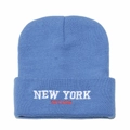 Close-up of white NEW YORK embroidery on sky blue knitted beanie hat with turn-up cuff - M(56-58cm) / Blue