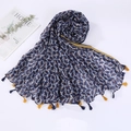 Detail view of navy blue cotton scarf with colorful patterns and yellow tassels - Style 11