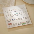 Coffret de boucles d'oreilles dorées avec perles et nœuds papillon sur support - E1954-1