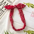 Elastic red paisley headband with bunny ear knot and classic cotton pattern print - Red