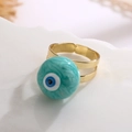 Macro detail of adjustable gold-plated evil eye ring on a white stone pedestal - Adjustable Open / Lake Blue (13417)