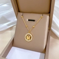 Elegant gold titanium steel necklace featuring a matte butterfly pendant in a jewelry box - Round Frame Matte Butterfly Gold (N214)