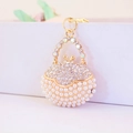 Golden handbag keychain with white pearls and sparkling rhinestones for women - White