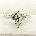 Irregular quadrilateral moss agate ring with side marquise zircons on a white ring box - US 6 / White Gold