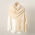 Close-up of beige linen scarf on a wooden hanger showing soft fabric texture - Beige