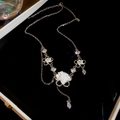 Detail of silver floral necklace with pearls and zircon tassels in a black gift box - Single Layer Necklace