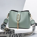 Light green bucket bag with wide 'LOVE' shoulder strap and gold tassel accent - Green