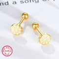 Macro detail of 925 sterling silver daisy stud earrings with white enamel and gold finish - Gold White