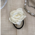 Large white satin rose hair tie with elastic black band on beige textured background - White Satin Rose Hair Rope (26)