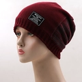 Detail of the chunky knit burgundy beanie with a woven street style label - One Size / Burgundy