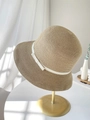 Detailed close-up of woven straw sun hat with a white bow on a display stand - M (56-58cm) / Khaki